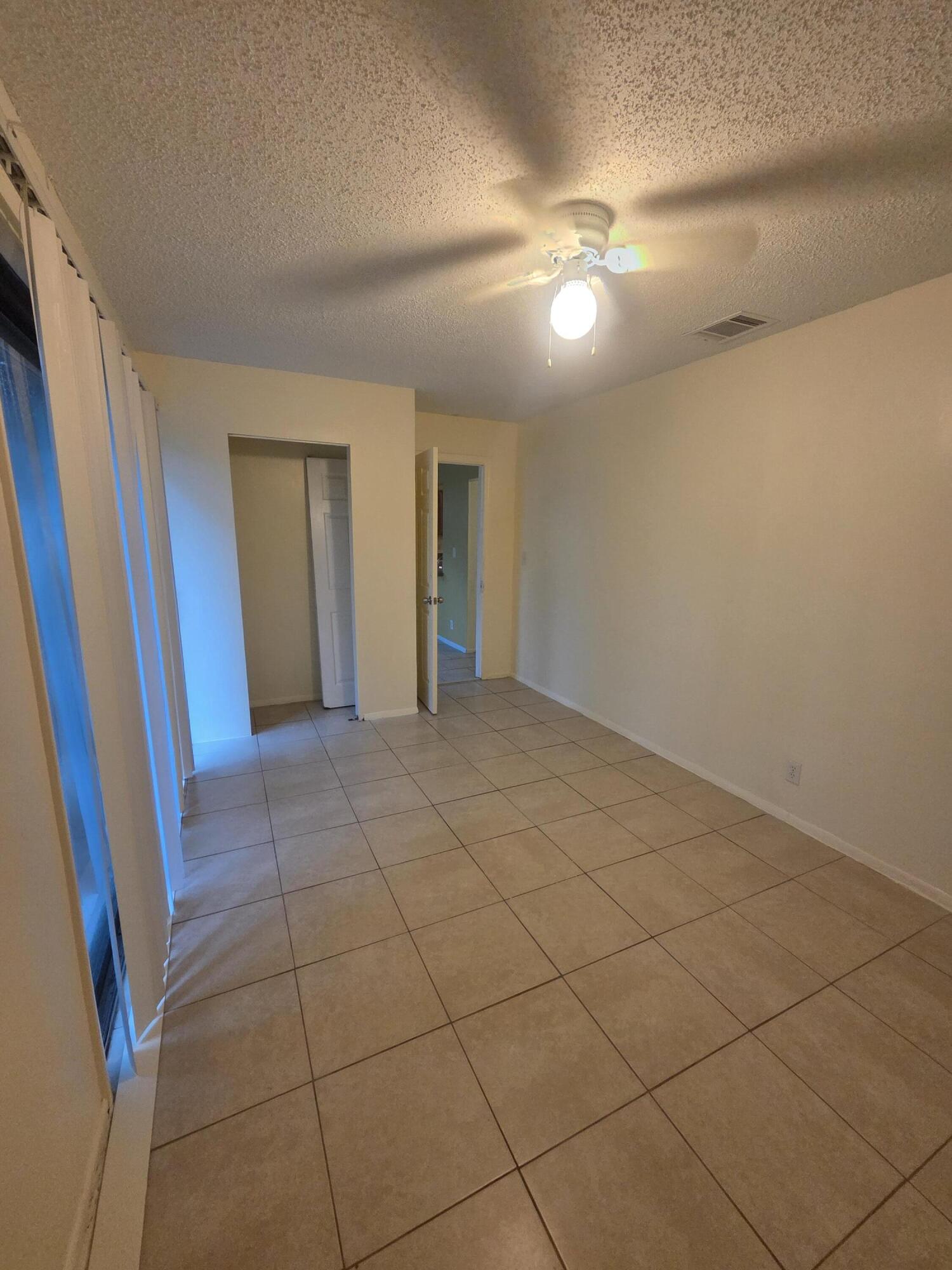 1917 Southeast Burgundy Lane Port St. Lucie, FL 34952 - Photo 6 of 13 a view of an empty room with a mirror
