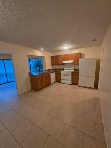 a kitchen with a sink cabinets and appliances