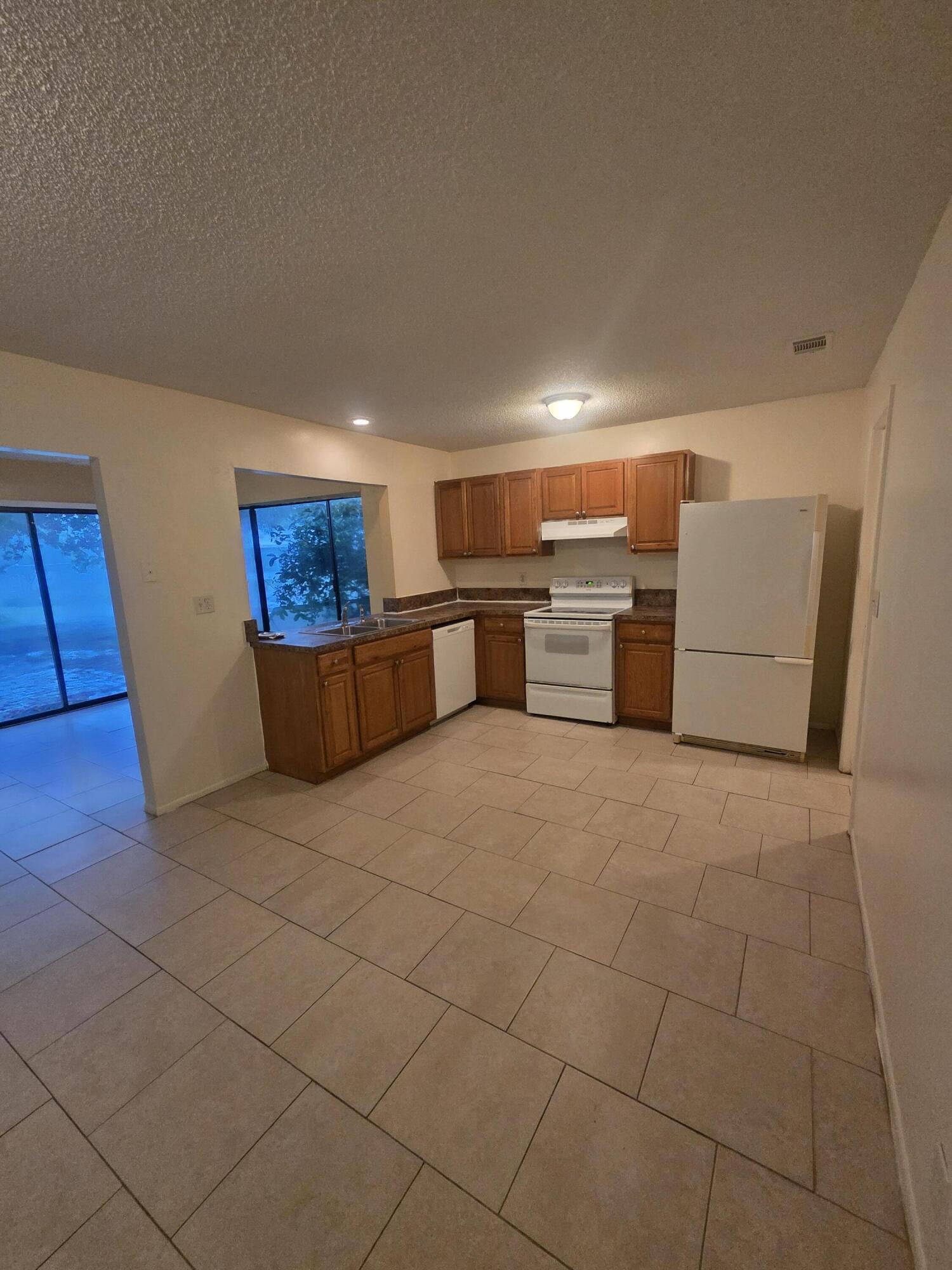 1917 Southeast Burgundy Lane Port St. Lucie, FL 34952 - Photo 8 of 13 a kitchen with a sink cabinets and appliances