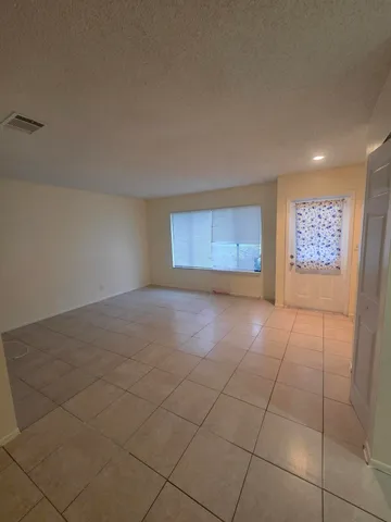 a view of an empty room and a window