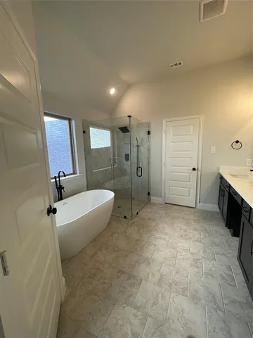 a spacious bathroom with a bathtub and a shower