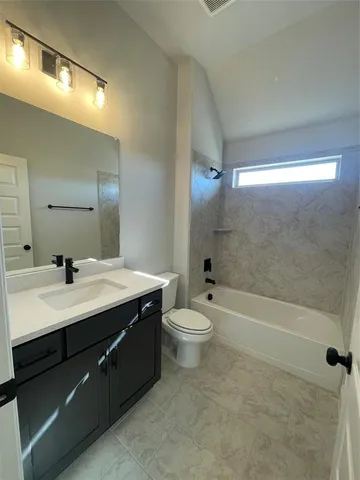 a bathroom with a double vanity sink toilet and shower