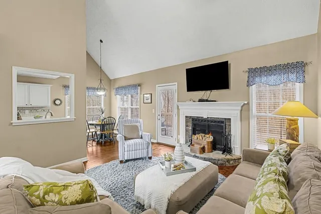 a living room with furniture fireplace and a flat screen tv