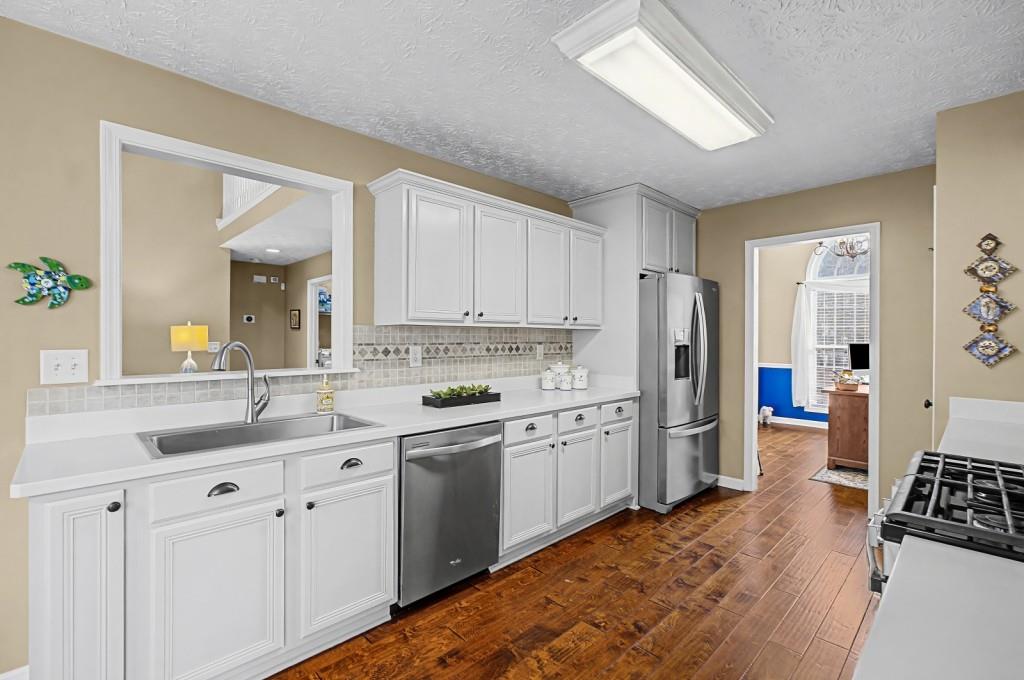 218 Amaranth Court Ball Ground, GA 30107 - Photo 16 of 46 a kitchen with a sink stove and refrigerator
