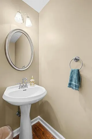 a bathroom with a sink a mirror and a toilet