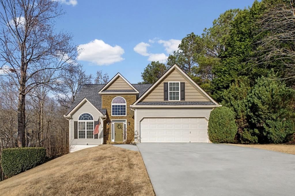 218 Amaranth Court Ball Ground, GA 30107 - Photo 2 of 46 a front view of a house with a yard and garage