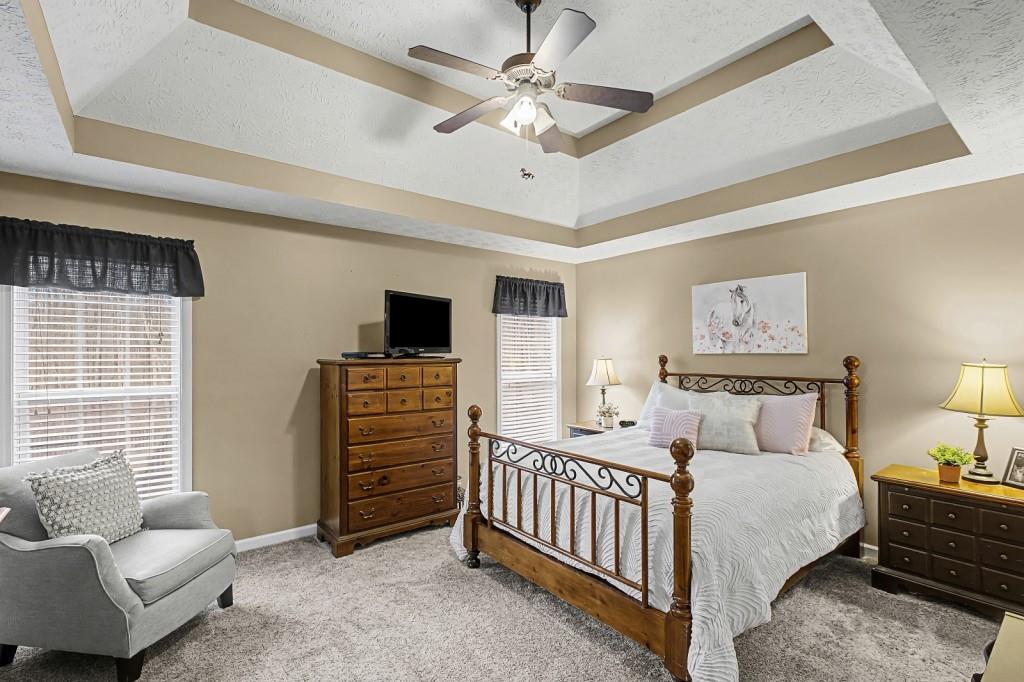 218 Amaranth Court Ball Ground, GA 30107 - Photo 21 of 46 a bedroom with furniture and a window