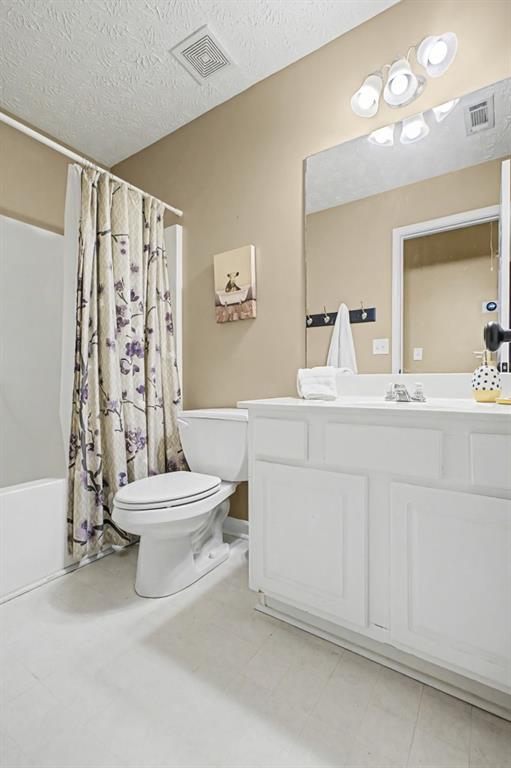 218 Amaranth Court Ball Ground, GA 30107 - Photo 30 of 46 a bathroom with a sink toilet a mirror and shower