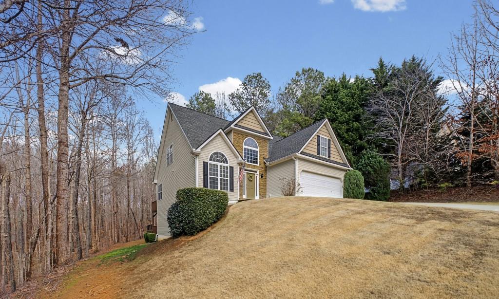 218 Amaranth Court Ball Ground, GA 30107 - Photo 4 of 46 a front view of a house with a yard and garage