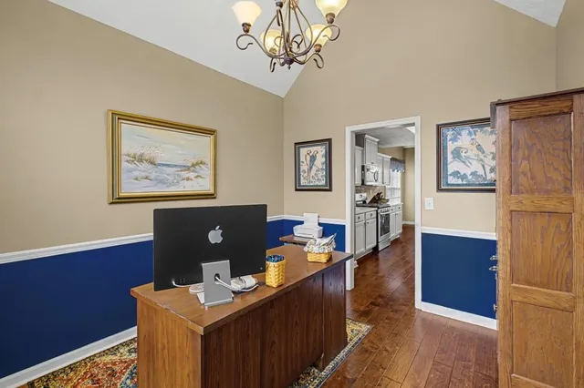 a view of a workspace with furniture and wooden floor