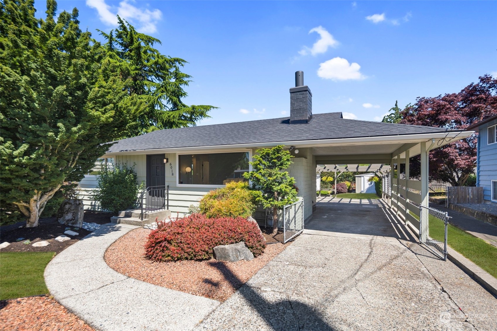 6018 South 119th Street Seattle, WA 98178 - Photo 1 of 33 a front view of a house with garden