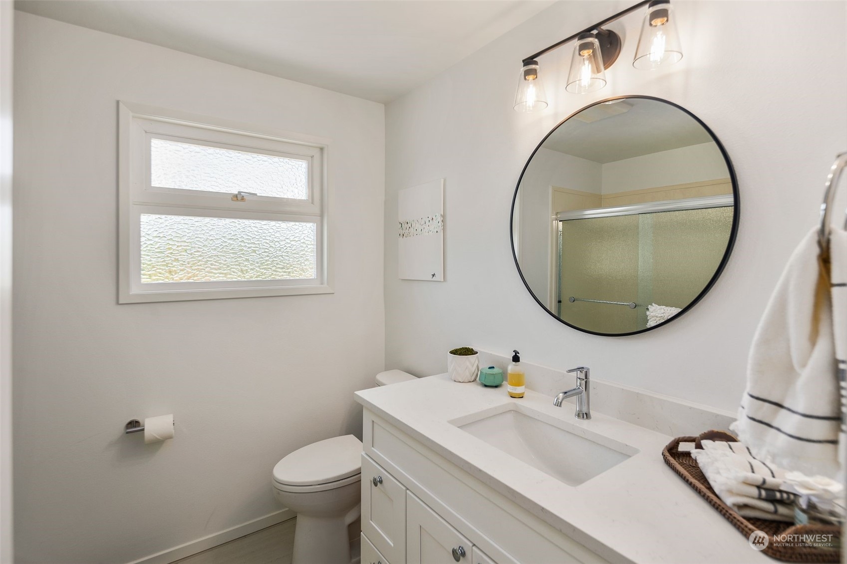 6018 South 119th Street Seattle, WA 98178 - Photo 17 of 33 a bathroom with a sink a toilet and a mirror