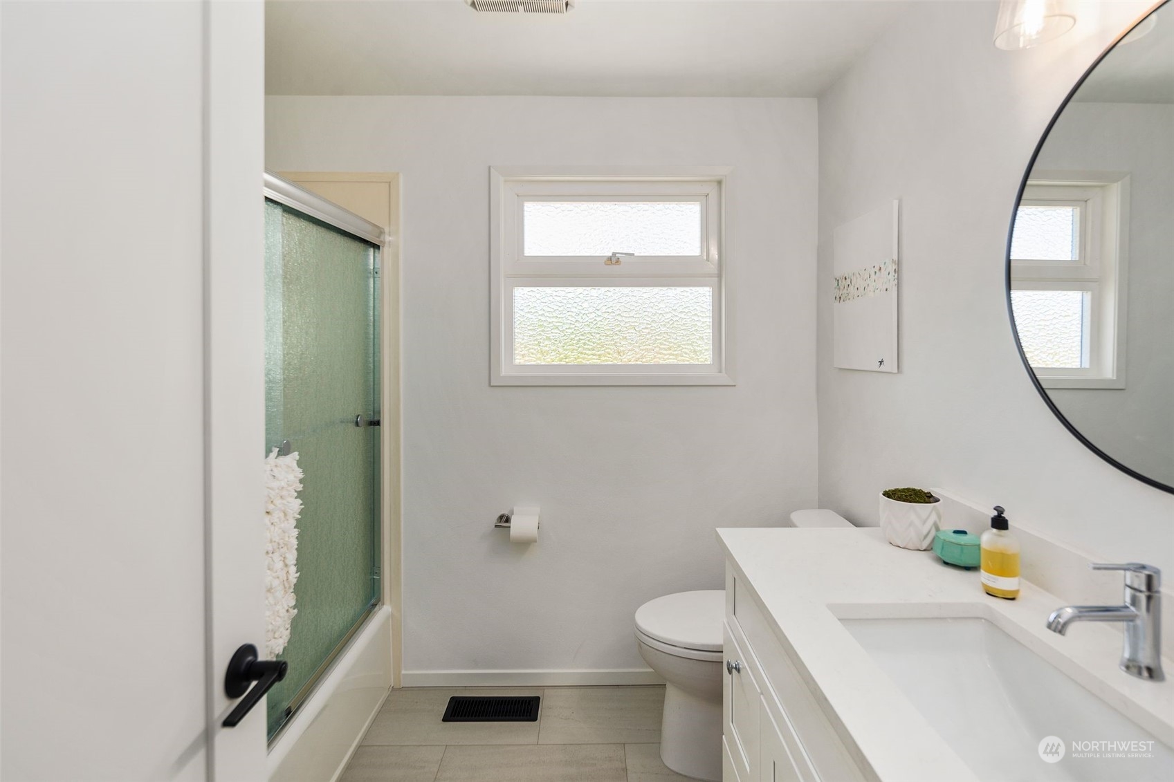 6018 South 119th Street Seattle, WA 98178 - Photo 18 of 33 a bathroom with a sink toilet and shower a mirror