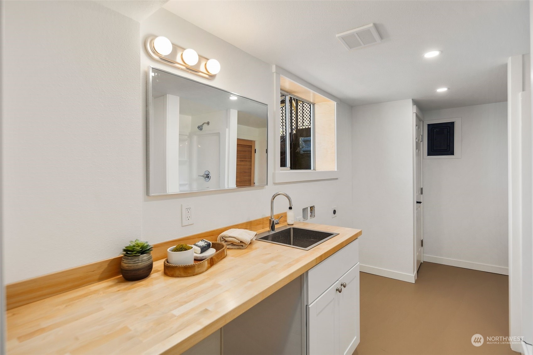 6018 South 119th Street Seattle, WA 98178 - Photo 24 of 33 a bathroom with a sink and a mirror