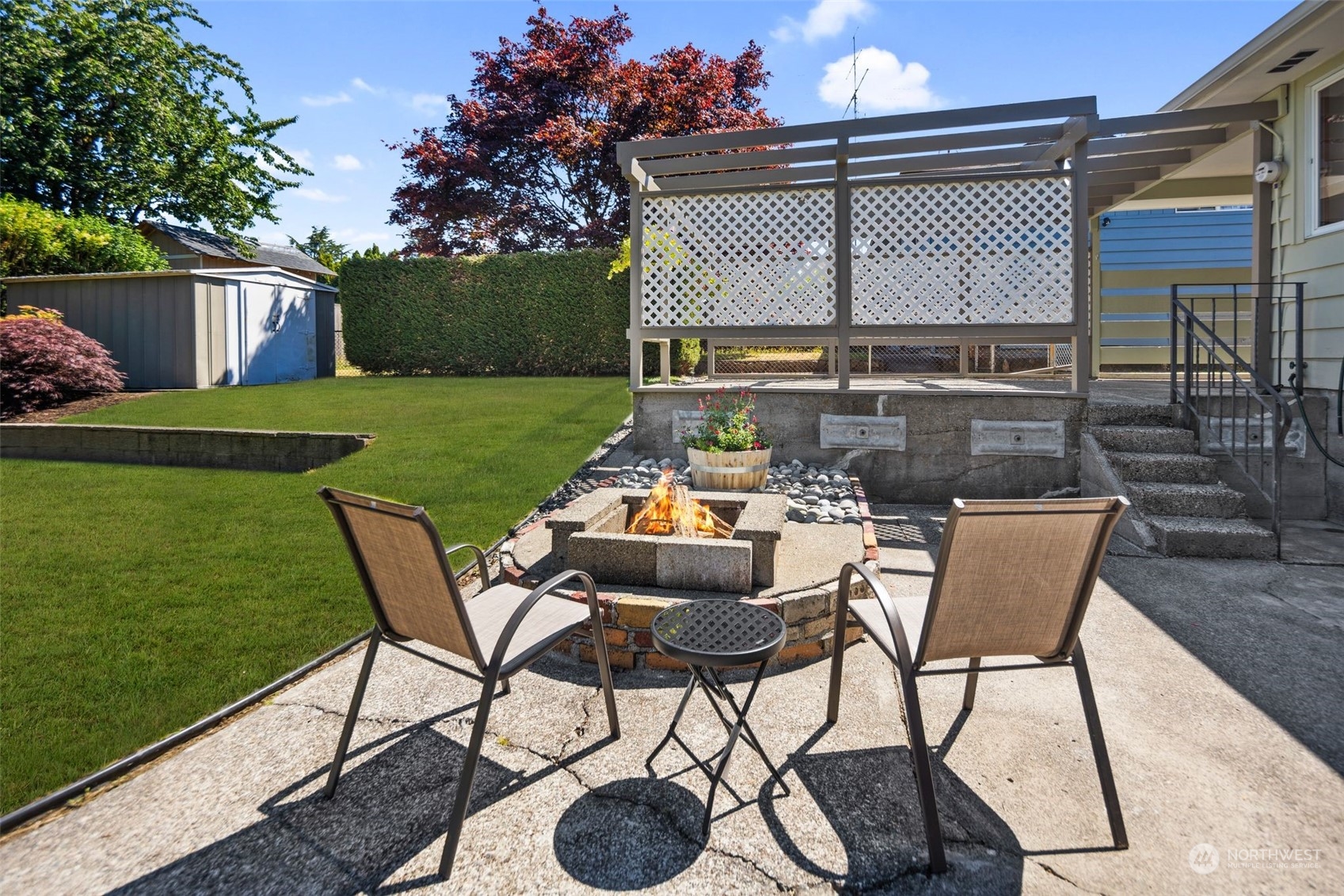 6018 South 119th Street Seattle, WA 98178 - Photo 28 of 33 a patio table and chairs with potted plants