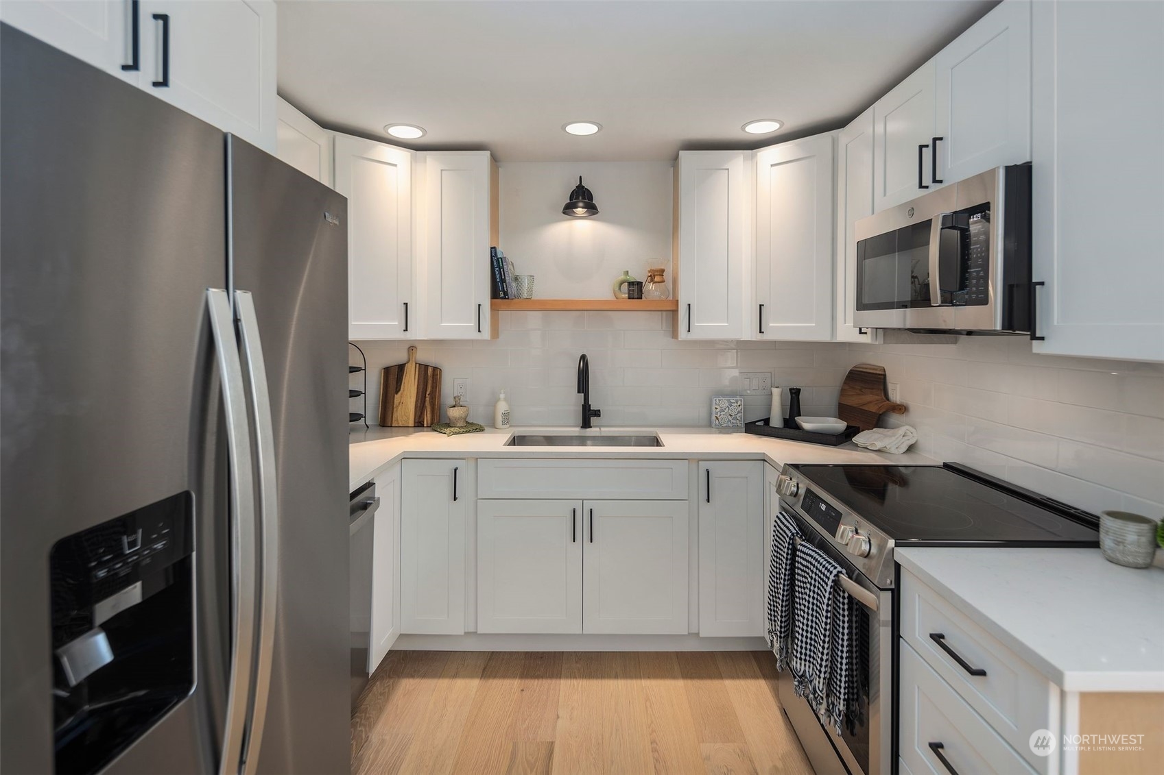 6018 South 119th Street Seattle, WA 98178 - Photo 6 of 33 a kitchen with a sink cabinets and stainless steel appliances