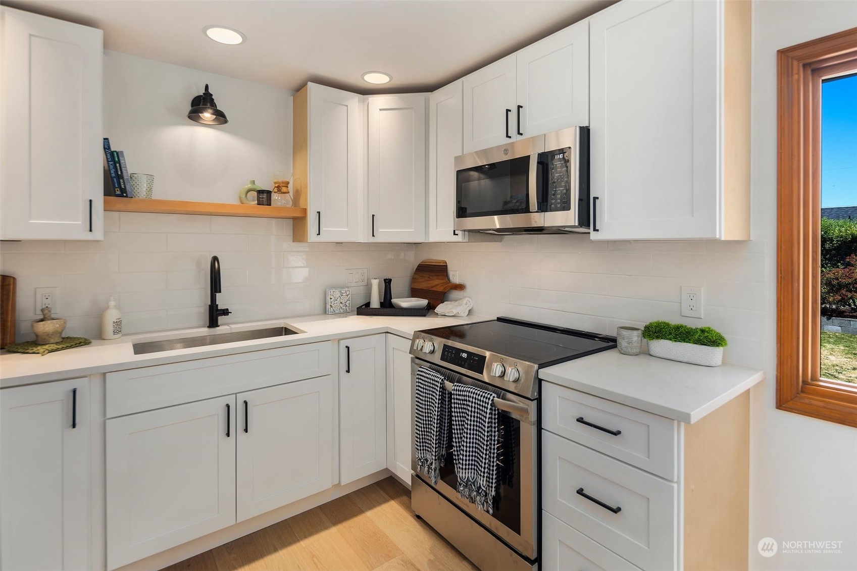 6018 South 119th Street Seattle, WA 98178 - Photo 7 of 33 a kitchen with white cabinets and appliances