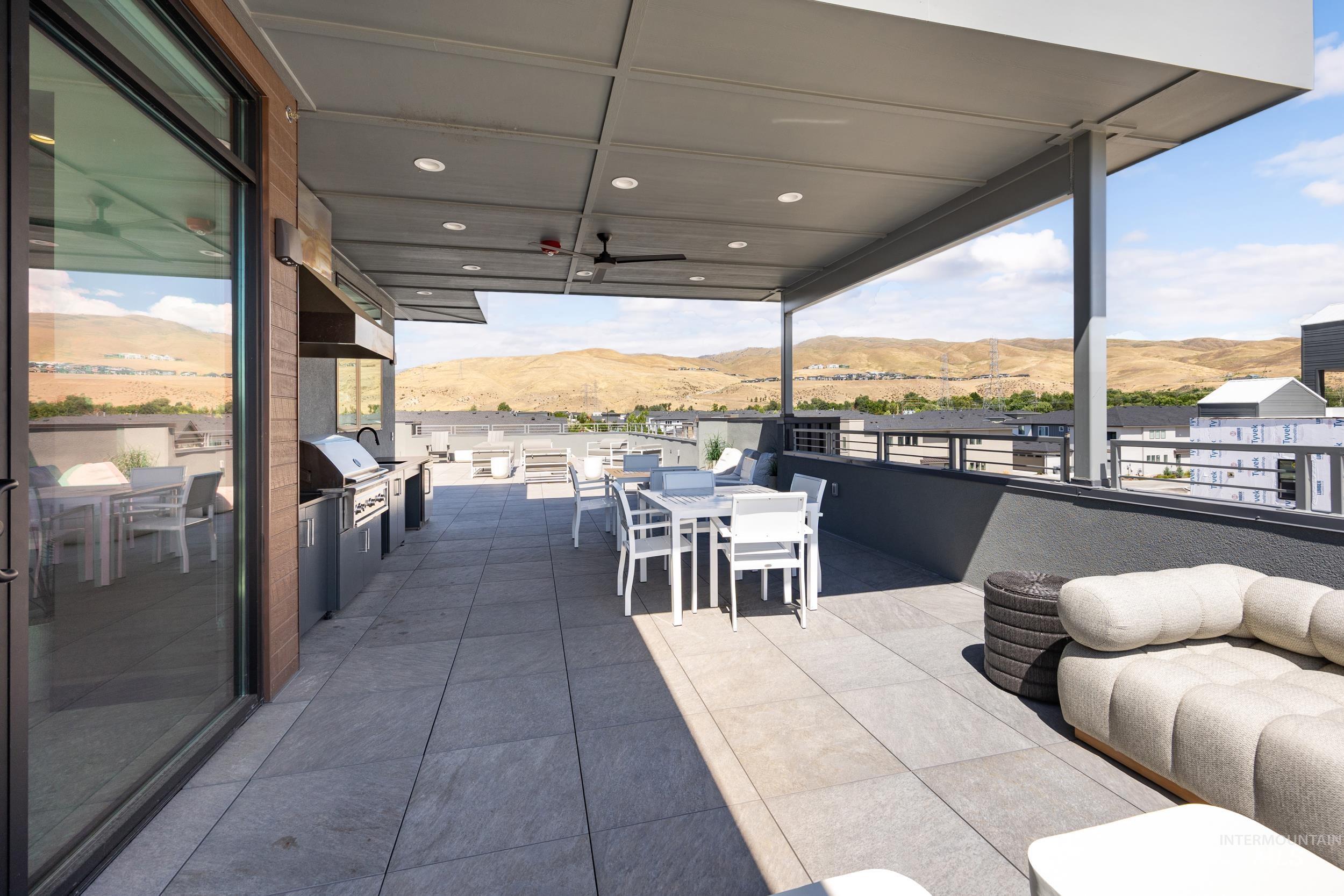 4340 East Haystack Street, Unit 206 Boise, ID 83716 - Photo 37 of 50 View of patio with a mountain view, outdoor dining area, area for grilling, and ceiling fan