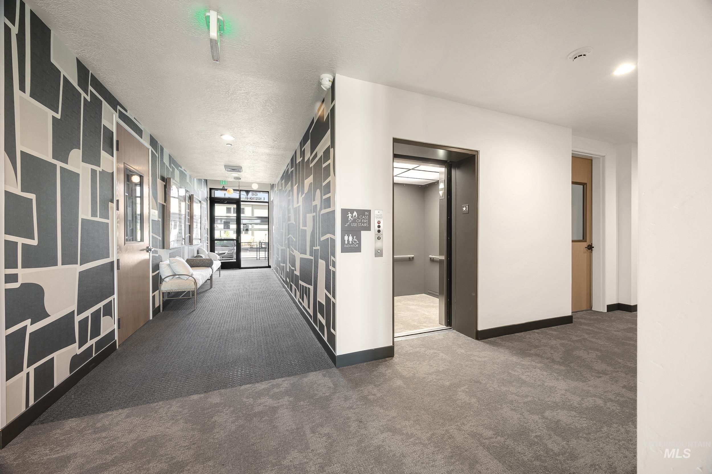 4340 East Haystack Street, Unit 206 Boise, ID 83716 - Photo 45 of 50 Corridor with carpet floors, elevator, a textured ceiling, and recessed lighting