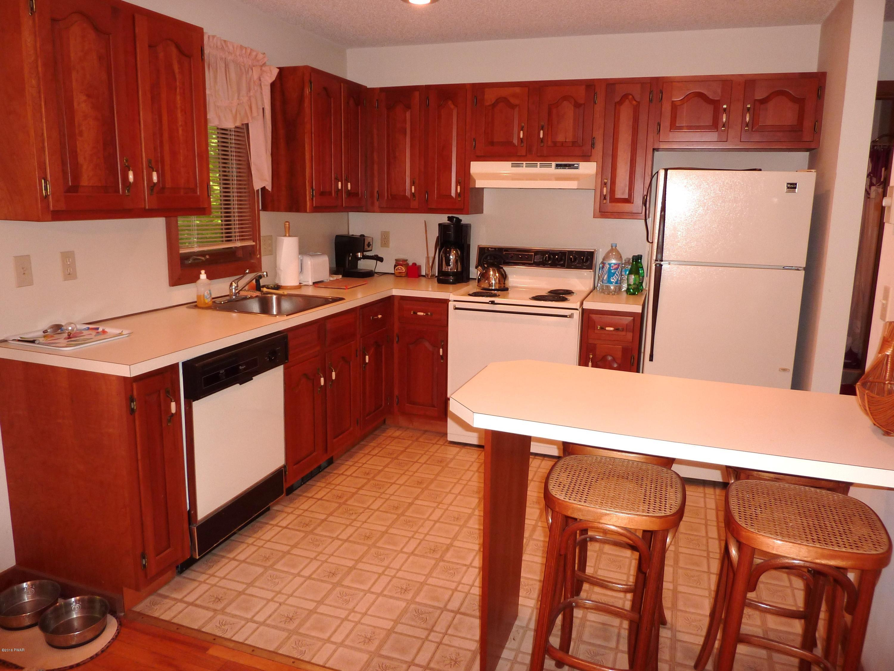 106 Valley Run Road Greentown, PA 18426 - Photo 2 of 21 a kitchen with stainless steel appliances a refrigerator a stove a sink and white cabinets