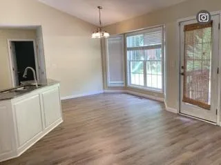 a view of a room with cabinet wooden floor and a window