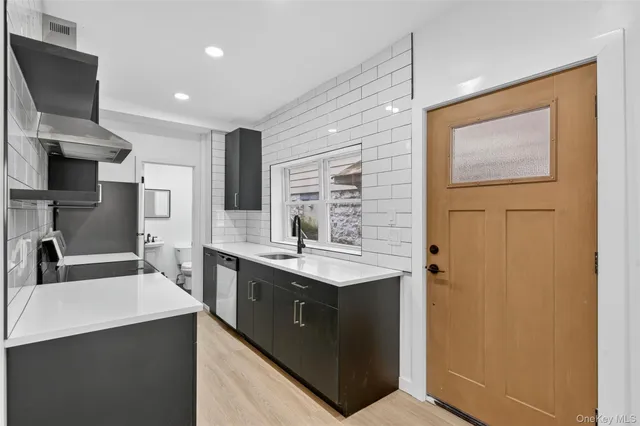 a kitchen with stainless steel appliances a sink stove and refrigerator