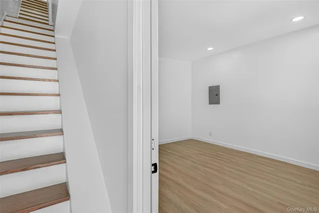 a view of hallway with wooden floor