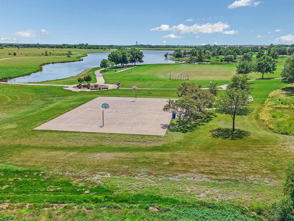 2009 Cooper Ridge Lane Heartland, TX 75126 - Photo 33 of 40 a view of a golf course with a lake