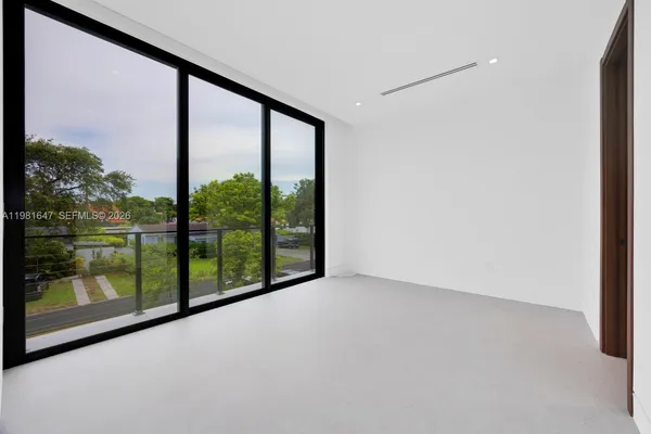 a large kitchen with a large window and stainless steel appliances
