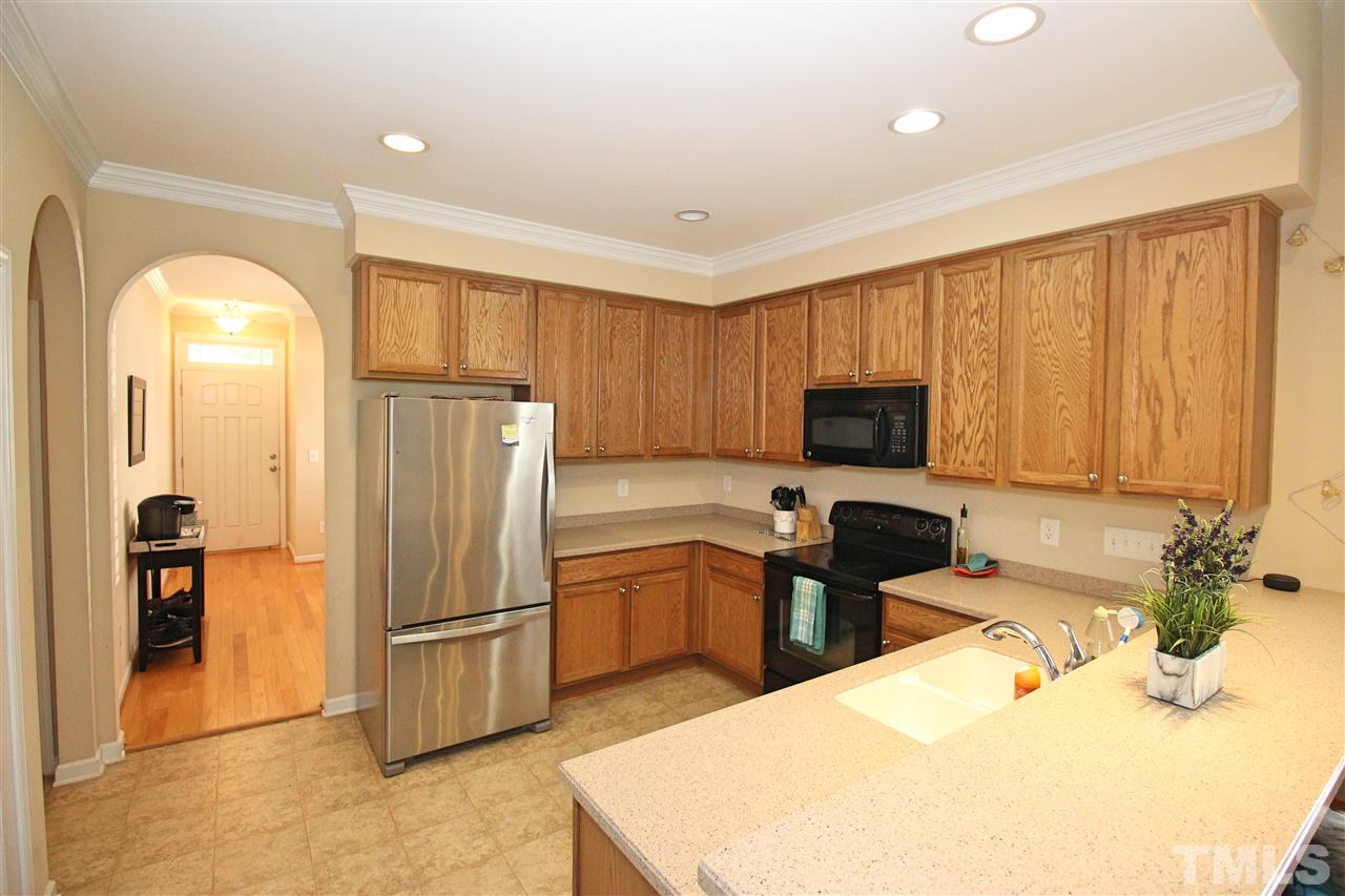 4720 Altha Street Raleigh, NC 27606 - Photo 3 of 11 a kitchen with granite countertop a refrigerator stove and sink
