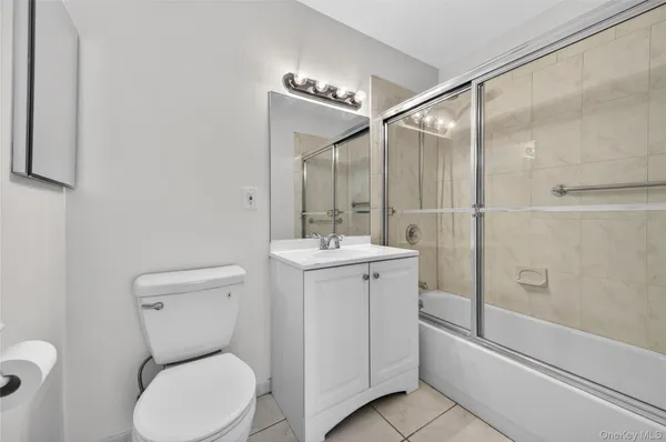 a bathroom with a toilet sink and shower