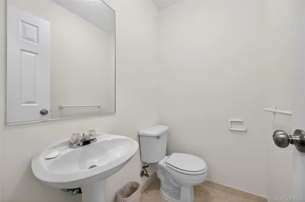 a bathroom with a sink a toilet and mirror