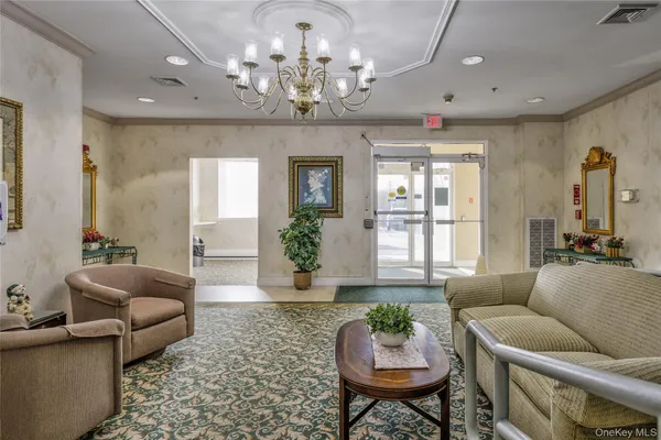 a living room with furniture chandelier and a chandelier