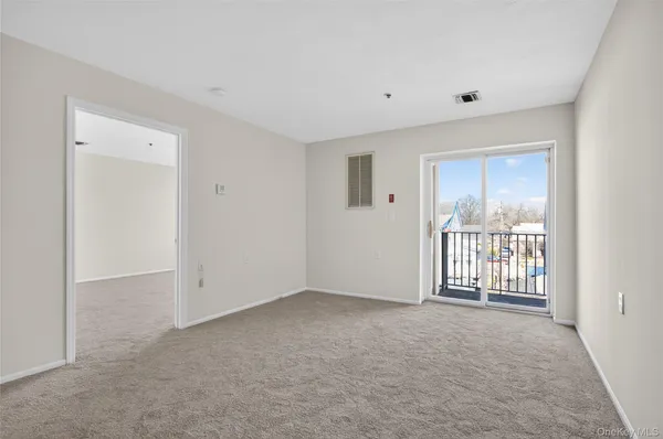 a view of an empty room with a window