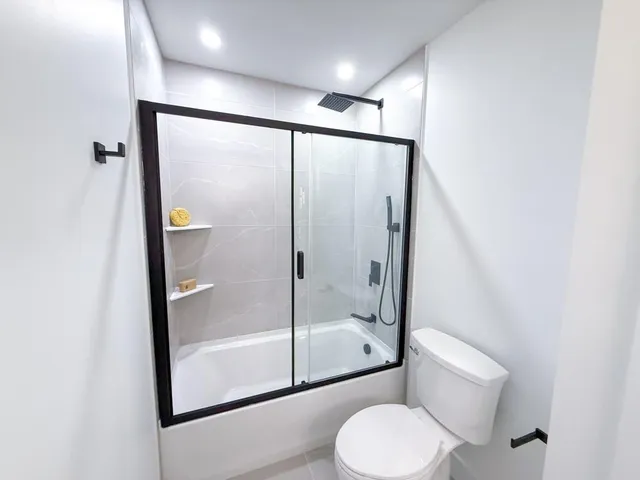 a bathroom with a toilet and a shower