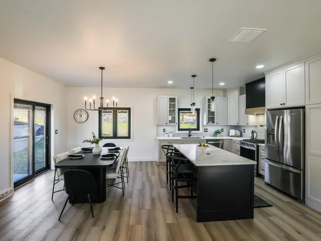 a kitchen with sink refrigerator and cabinets