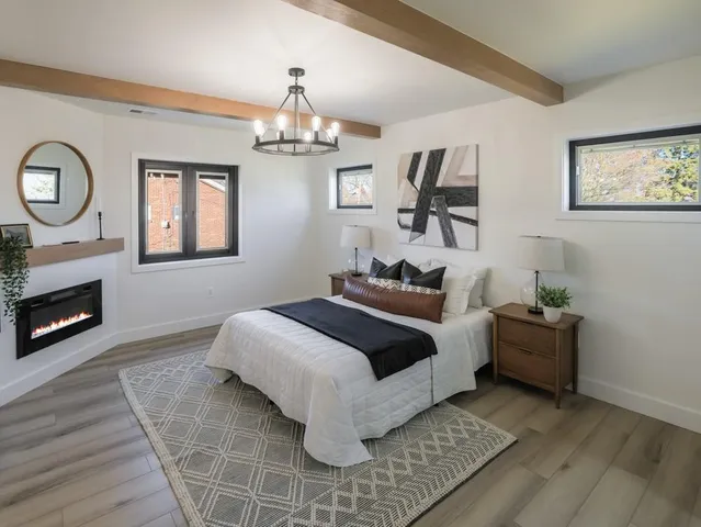 a spacious bedroom with a bed and a chandelier