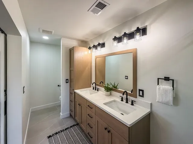 a bathroom with a sink a mirror and a shower