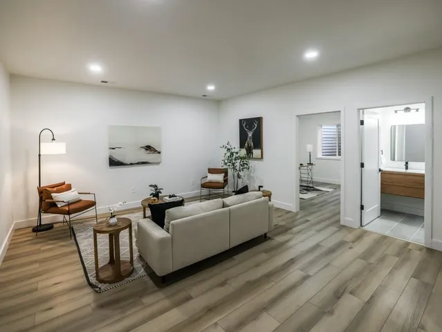 a living room with furniture and a wooden floor
