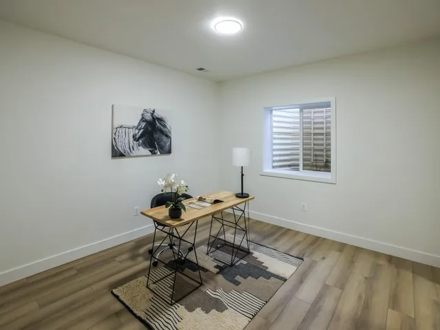 a workspace room with furniture and window