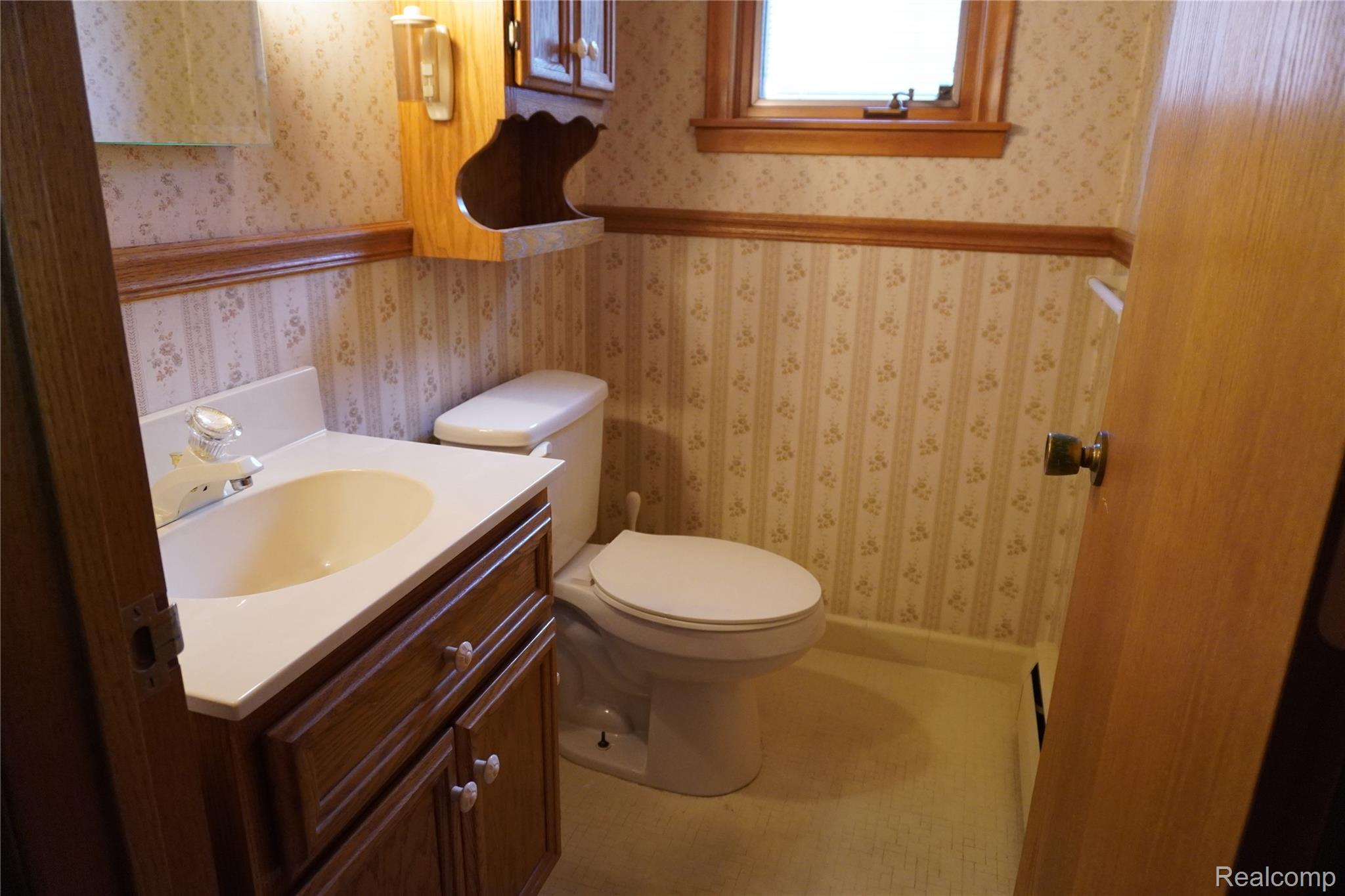 8115 Busch Street Center Line, MI 48015 - Photo 3 of 19 Half bath with vanity and wallpapered walls