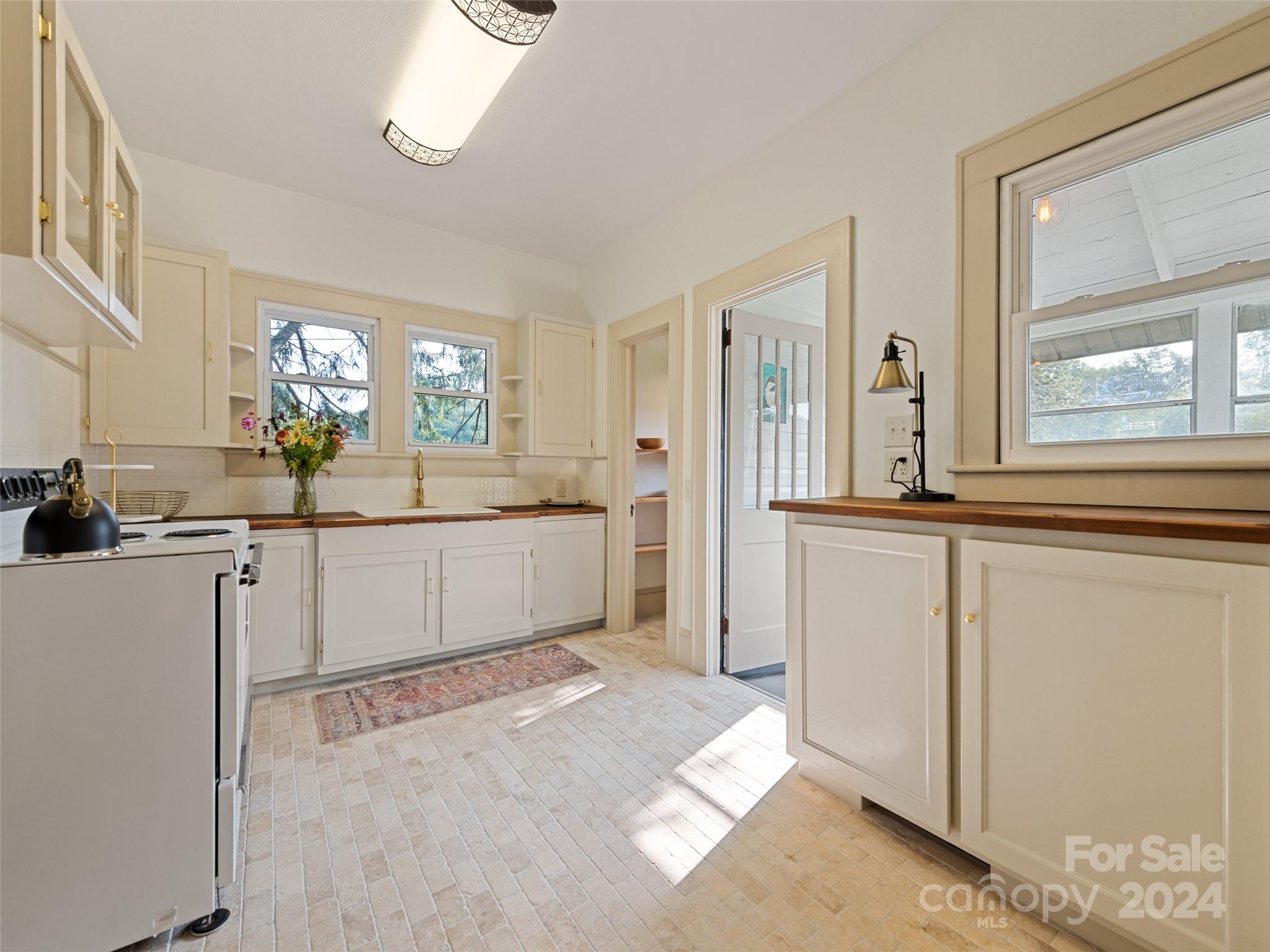 15 Scottdale Road Canton, NC 28716 - Photo 13 of 30 a view of a kitchen with a sink and windows
