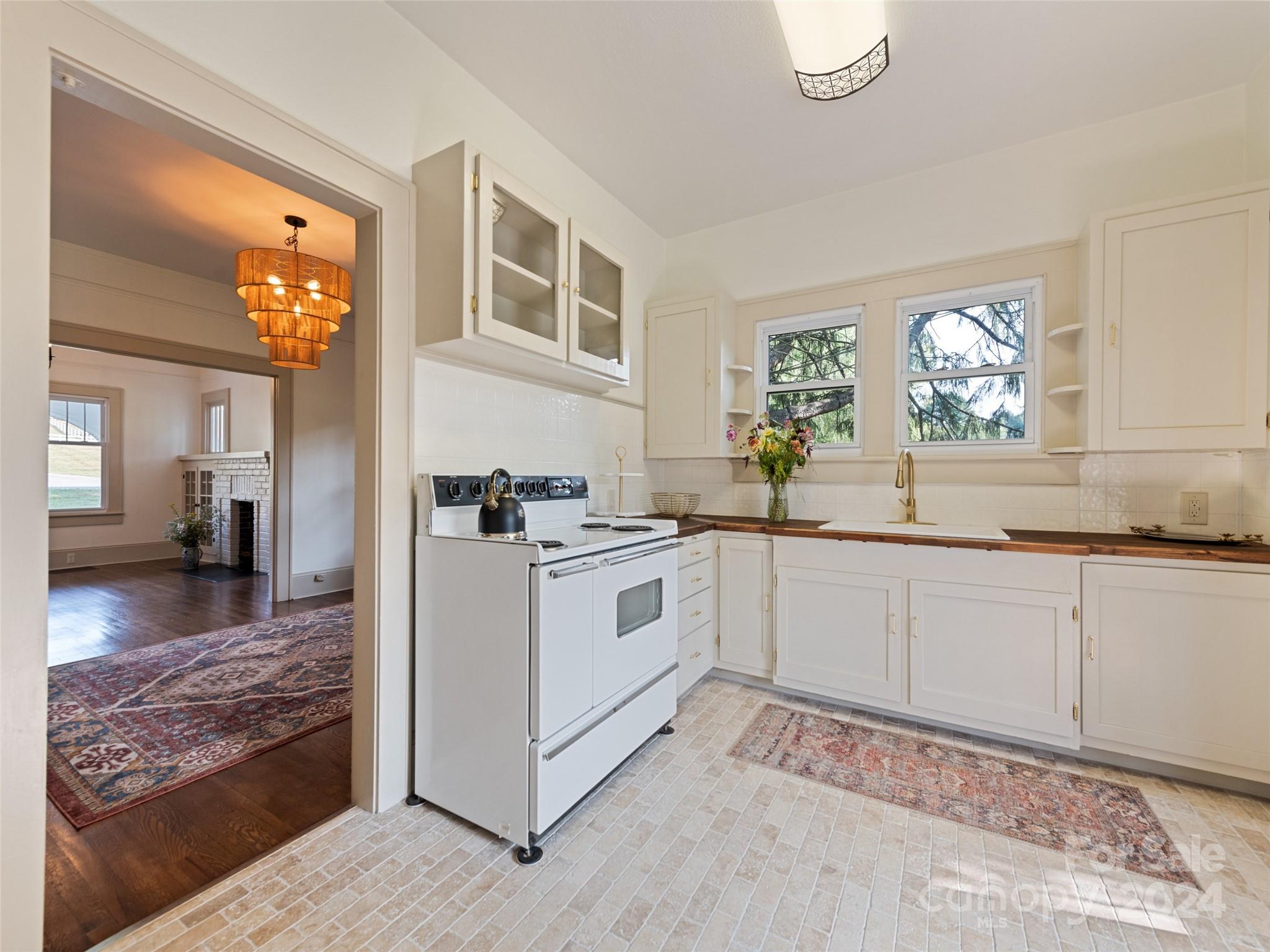 15 Scottdale Road Canton, NC 28716 - Photo 14 of 30 a kitchen with granite countertop white cabinets and white appliances
