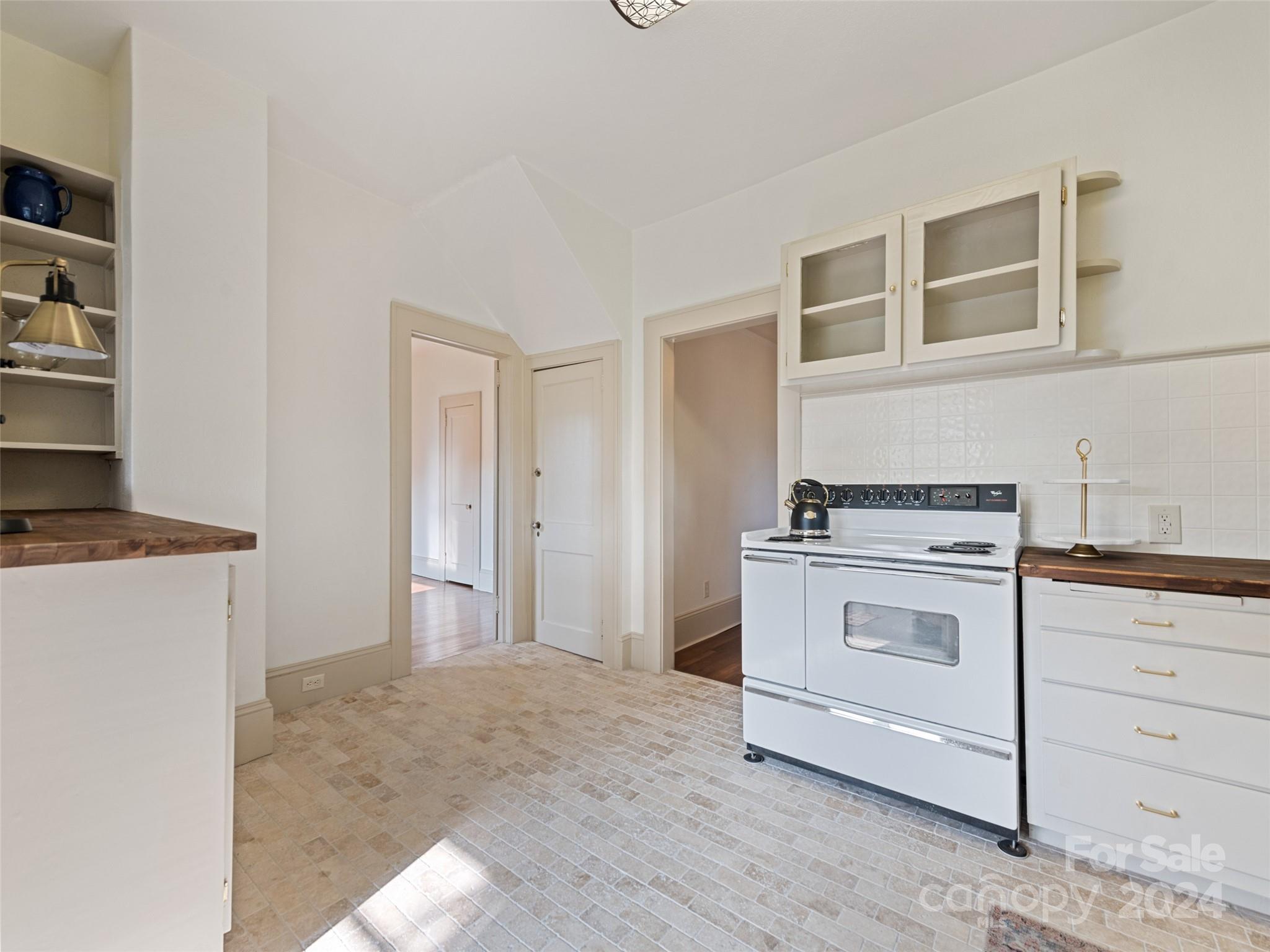 15 Scottdale Road Canton, NC 28716 - Photo 16 of 30 a kitchen with a stove and a refrigerator