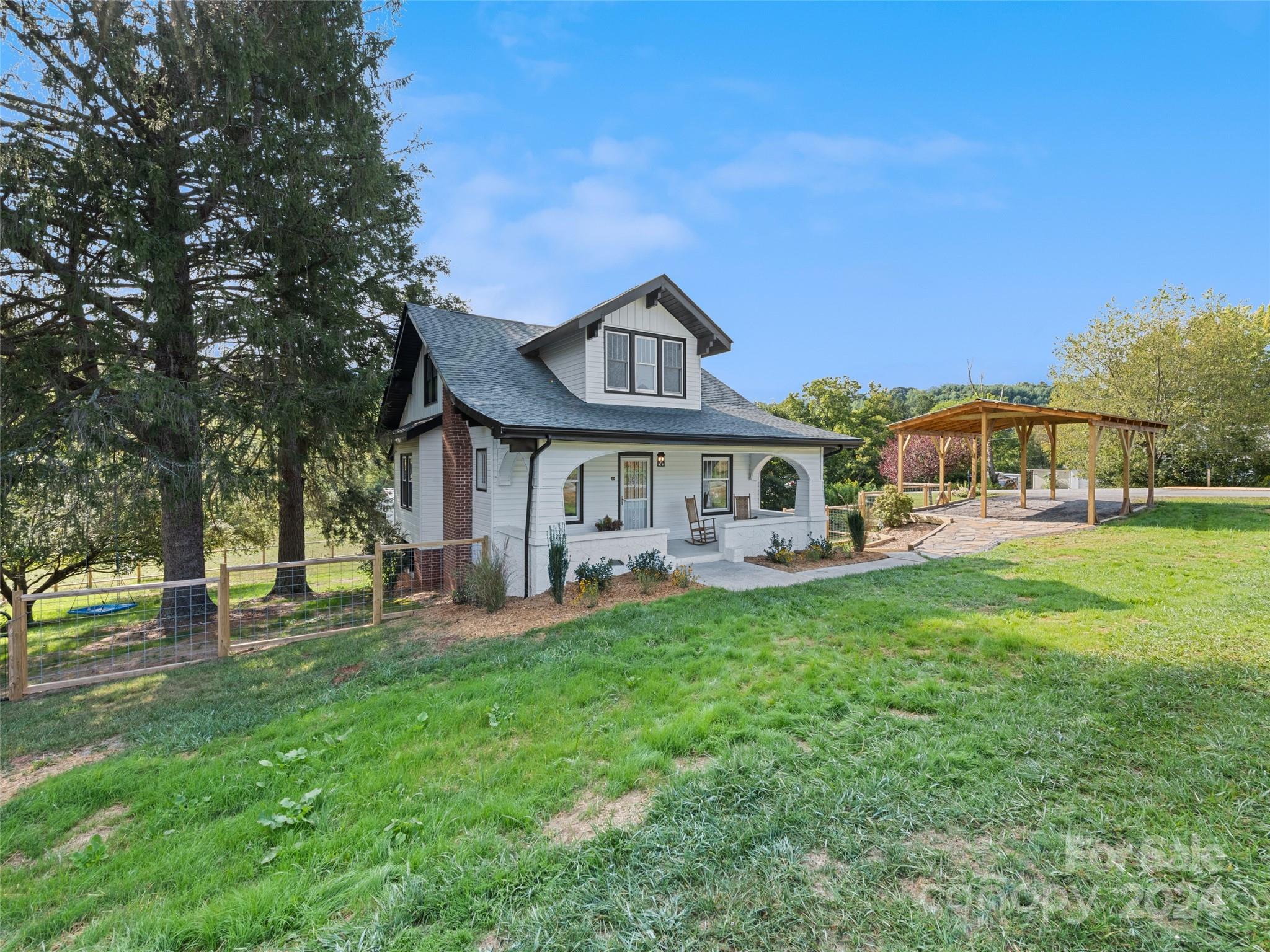 15 Scottdale Road Canton, NC 28716 - Photo 2 of 30 a front view of a house with garden and trees