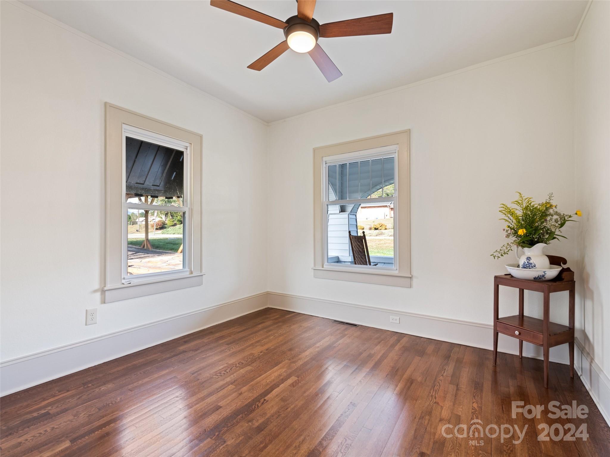 15 Scottdale Road Canton, NC 28716 - Photo 22 of 30 a view of an empty room with wooden floor and a window