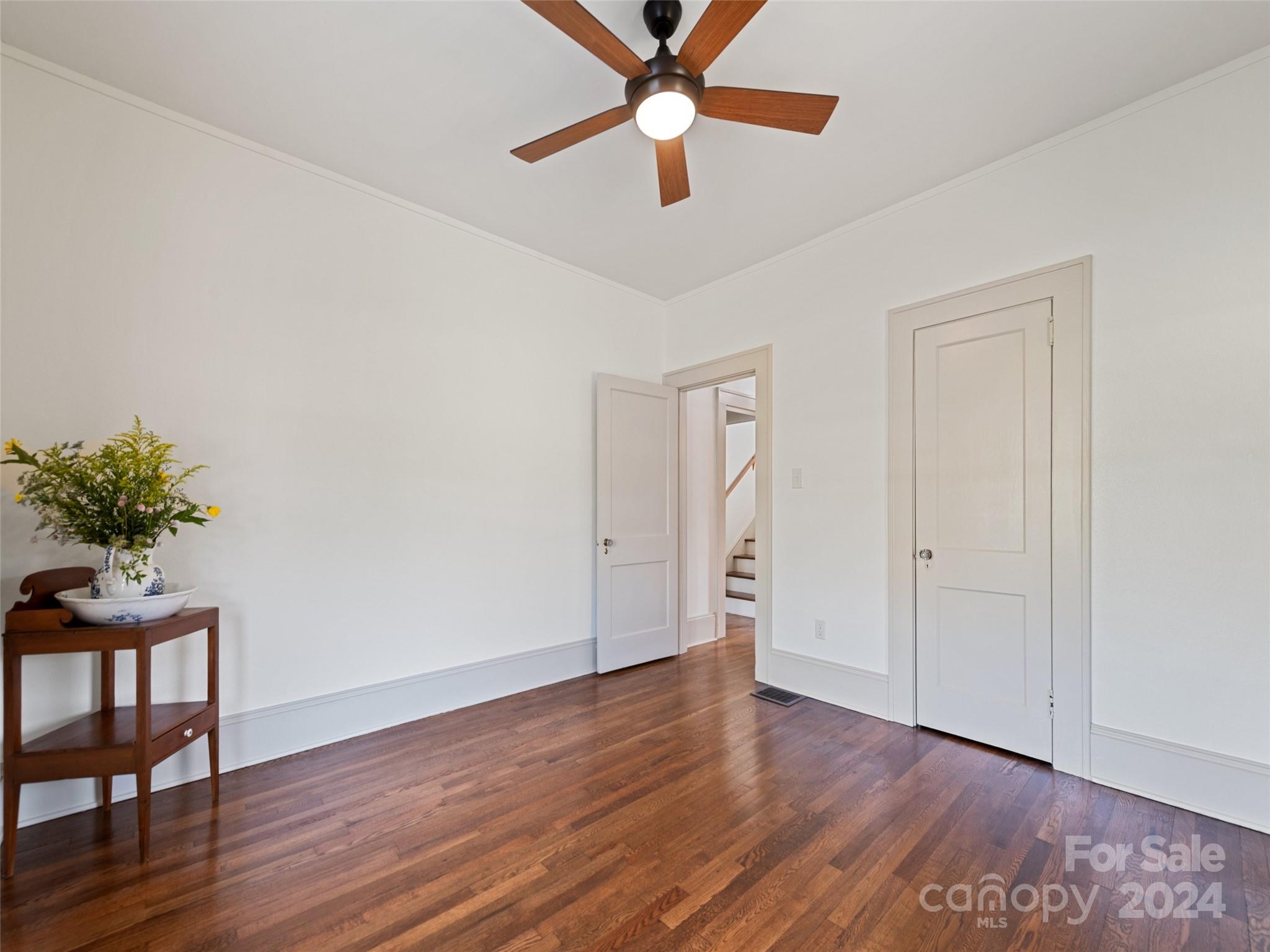 15 Scottdale Road Canton, NC 28716 - Photo 23 of 30 a view of a room with wooden floor and a ceiling fan