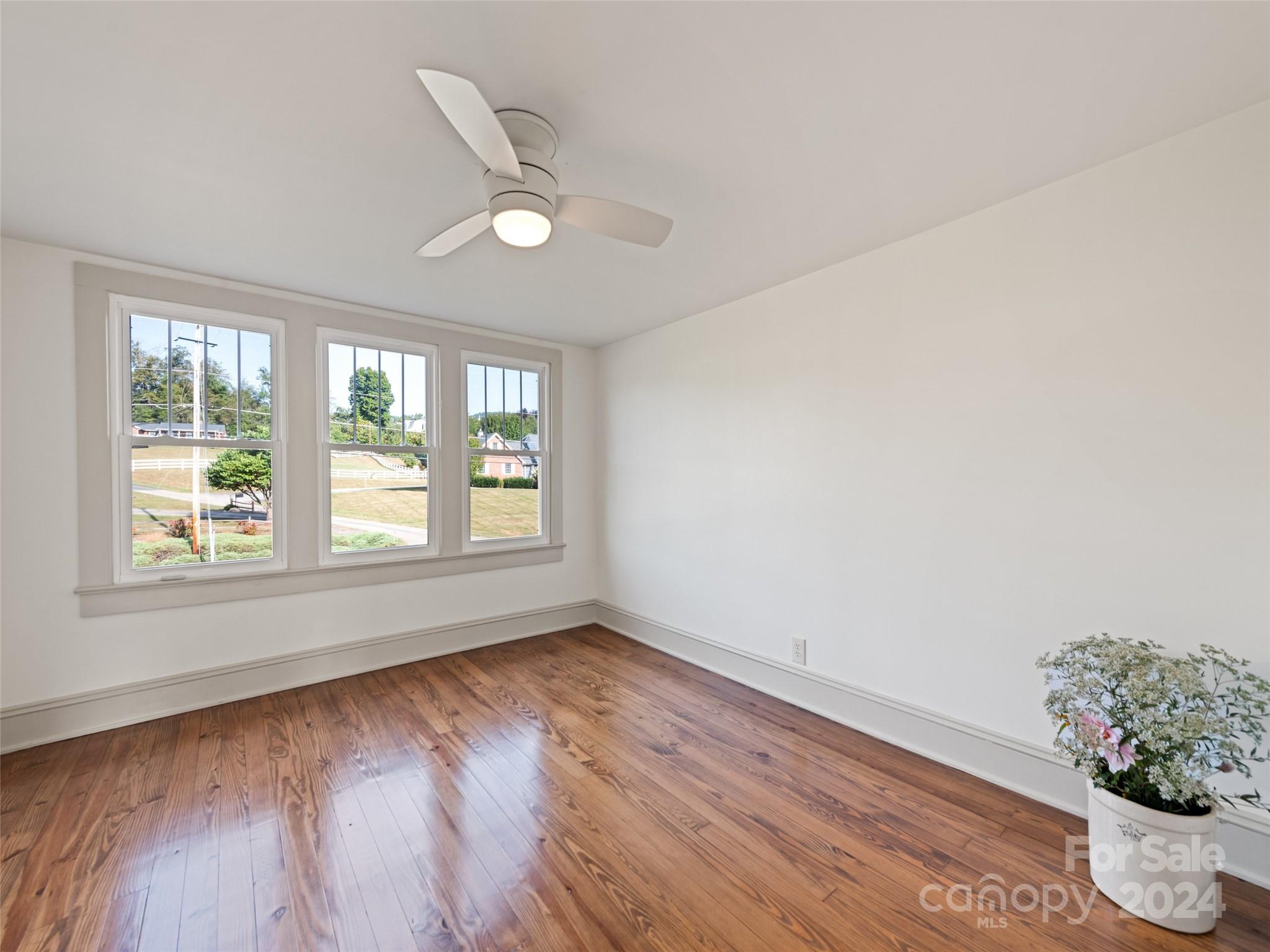 15 Scottdale Road Canton, NC 28716 - Photo 24 of 30 a view of an empty room with wooden floor and a window