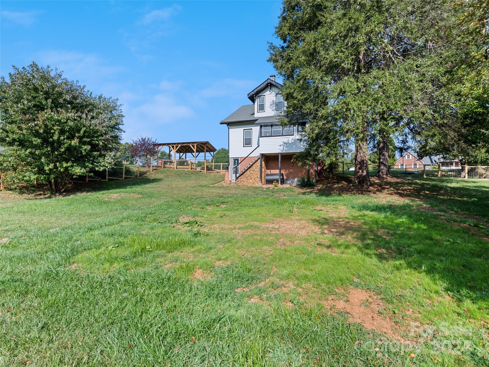 15 Scottdale Road Canton, NC 28716 - Photo 5 of 30 a view of a house with a big yard and large trees