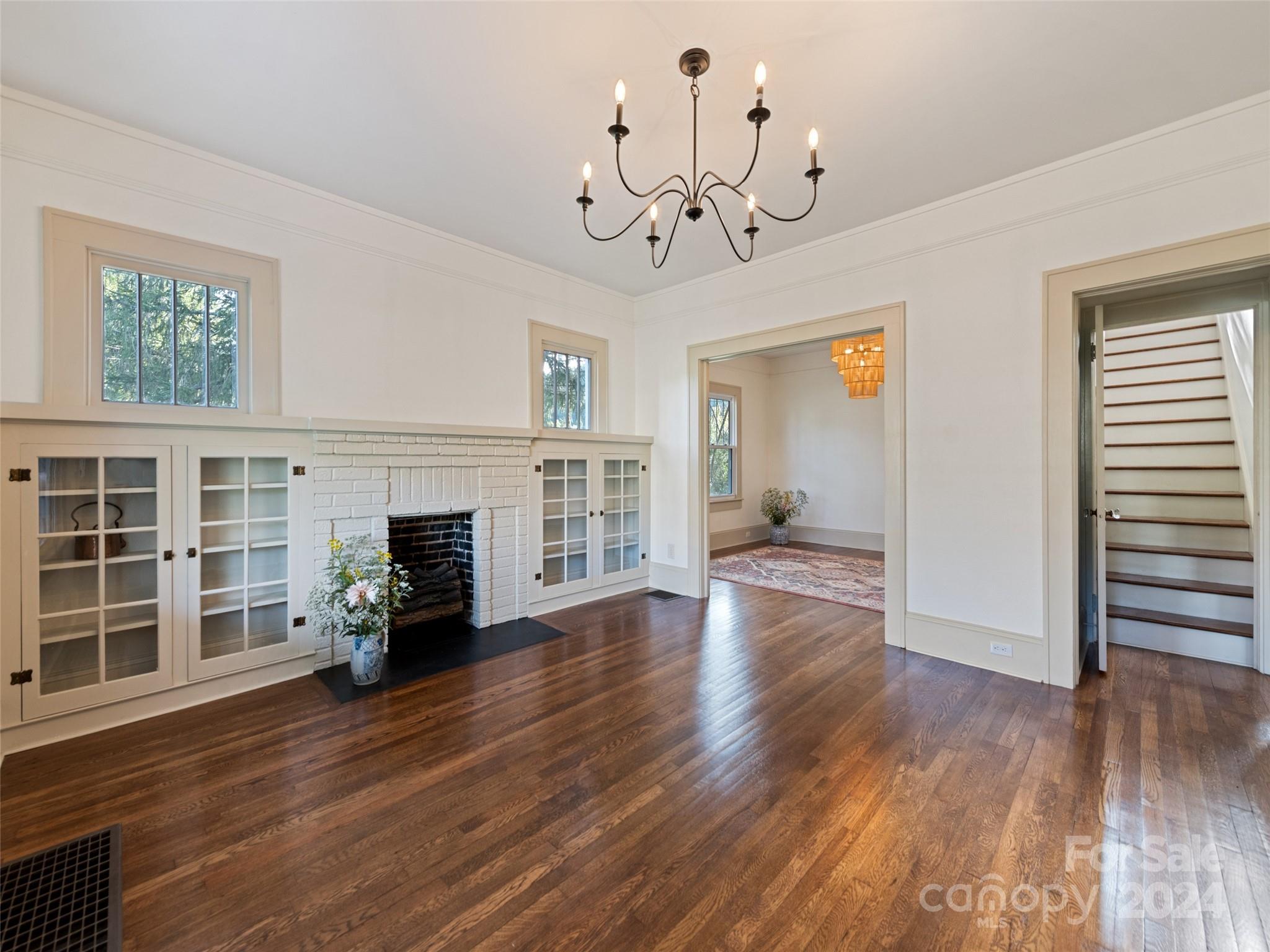 15 Scottdale Road Canton, NC 28716 - Photo 7 of 30 a view of a livingroom with wooden floor a fireplace and windows
